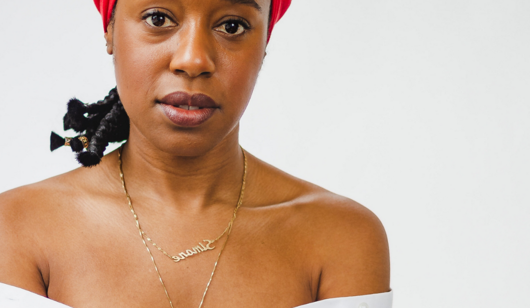 Black woman with bare shoulders, wearing a red scarf, relaxing in therapy and taking a break from the stresses of daily life