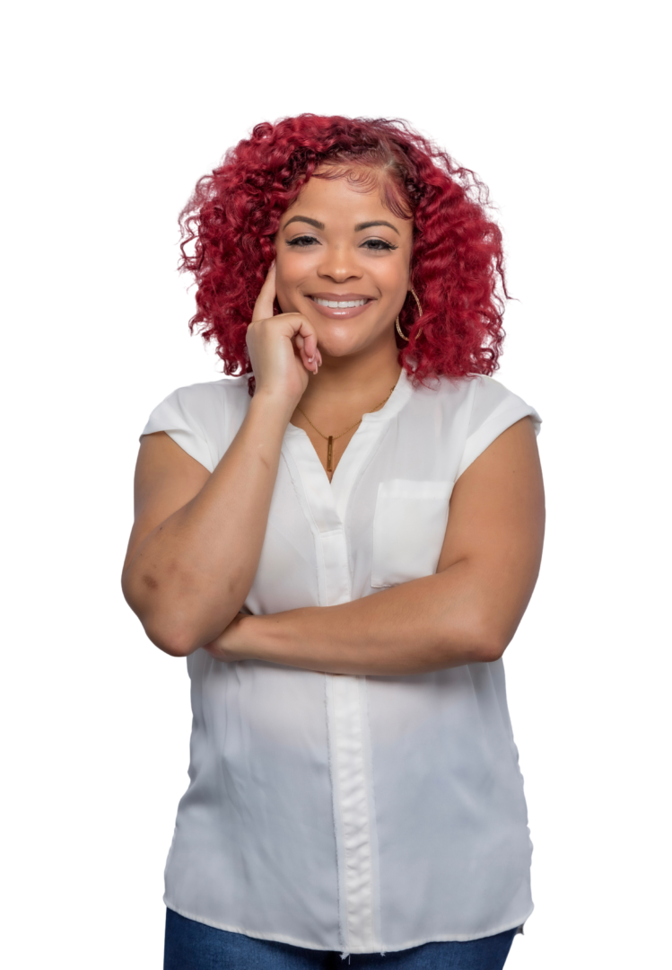 Smiling Black woman therapist with natural hair, wearing a white top, in her Atlanta, Georgia office, specializing in trauma therapy and emotional support.