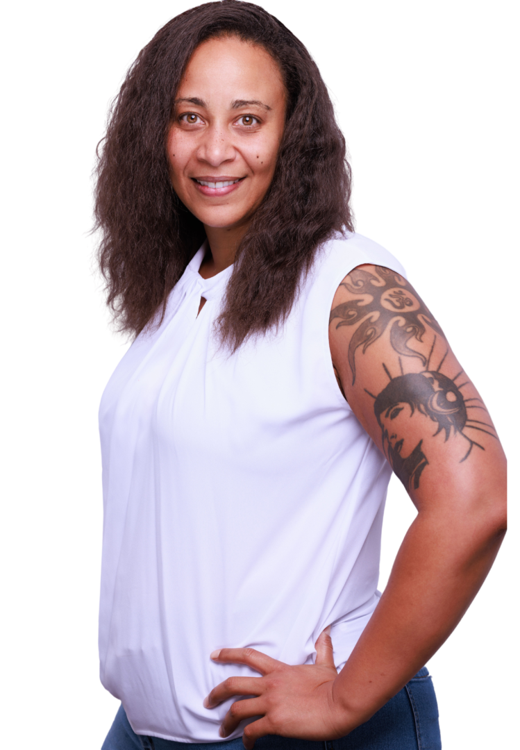 Smiling Black woman anxiety therapist with natural hair, wearing a white top, in her Atlanta, Georgia office, offering a welcoming and therapeutic environment
