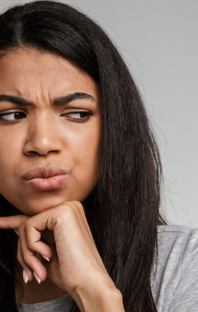 Therapy for Black Women in Atlanta | Addressing Microaggressions & Mental Health | 30080 | 30339 | 30067 | 30213 | 30097 Woman looking confused following sting of microaggression. Therapist helping Black women address microaggressions and mental health challenges in Atlanta