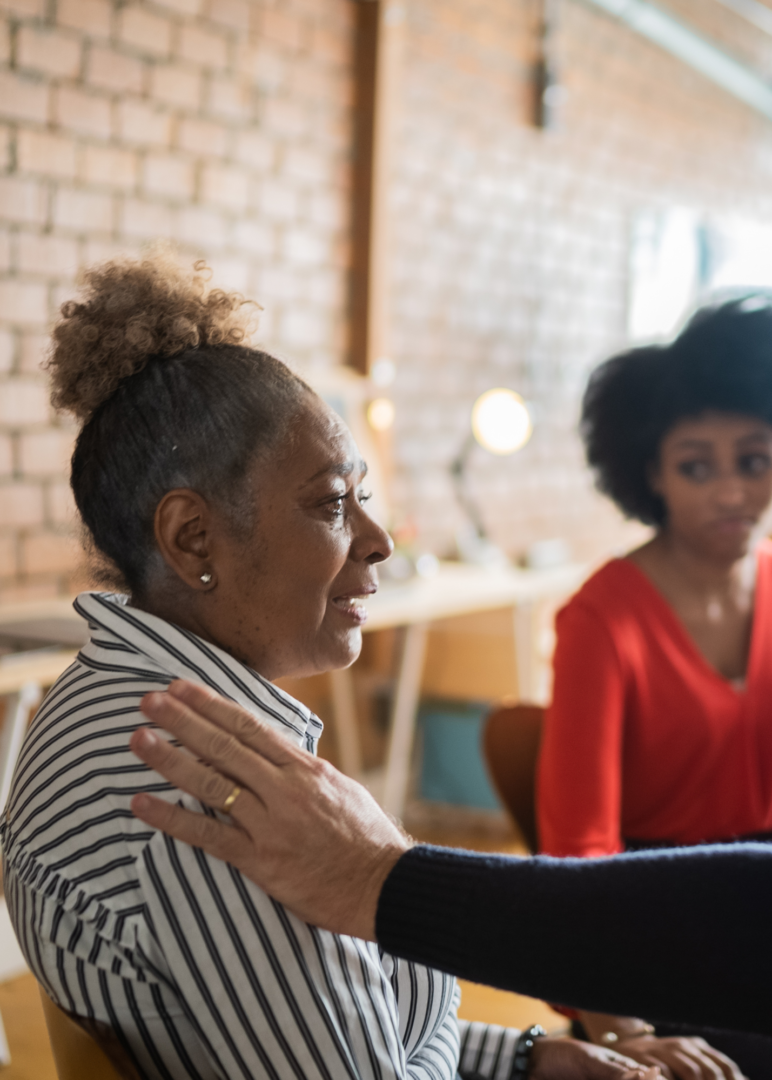Empowering Women Through Group Therapy | Laughter & Connection | 30263 | 30044 | 30179 | 30268 | 30809 Lending a hand to a group member in in Atlanta group therapy, creating connections and empowering each other