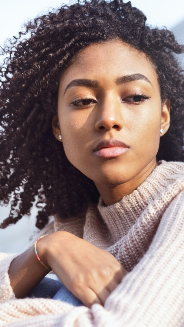 brown sweater | grief counseling in Atlanta, GA | Atlanta grief counselor | grief and loss counseling in Atlanta | 30135 | 30004 | 30034 Image of an African American woman looking off to the side. Representing the pain that grief and loss counseling can help with. During grief counseling in Atlanta, GA a grief counselor will help you make sense of life after loss.
