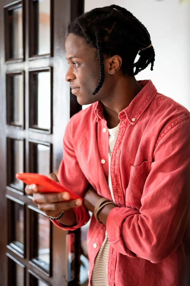 Image of an African America male looking thoughtful. Representing the benefits of therapy for Black men on mental health in the Black community in Atlanta, GA.