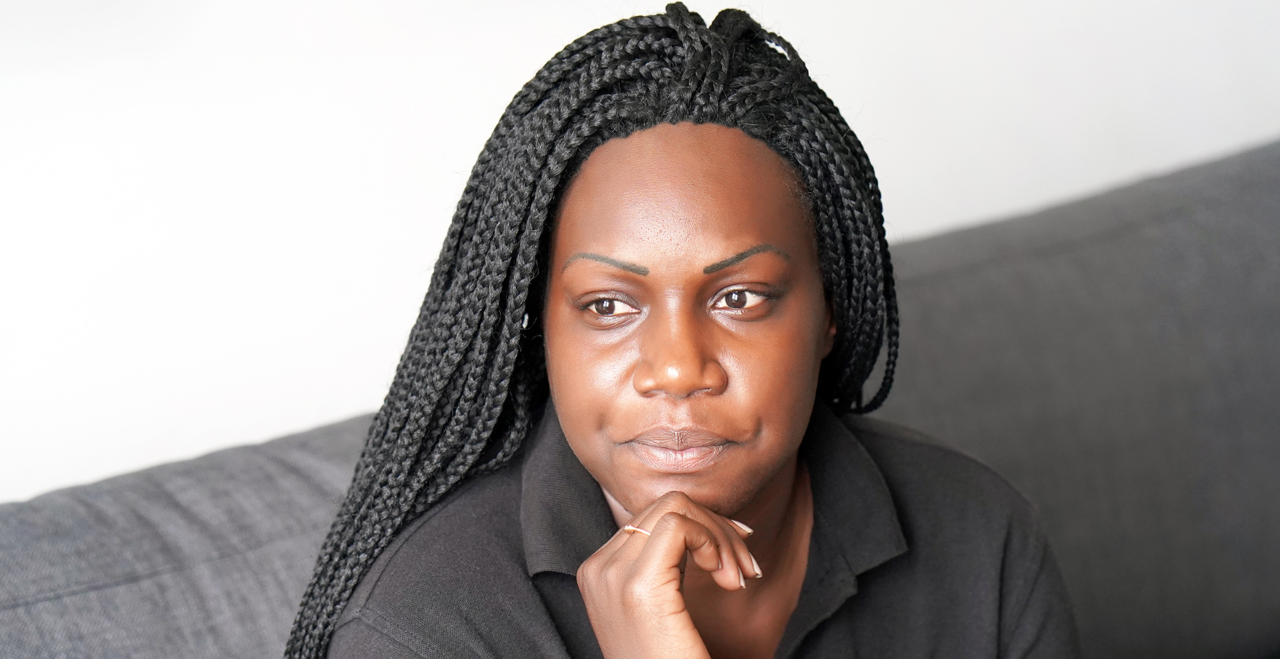 black shirt | grief and loss counseling in Atlanta | grief specialists in Atlanta, GA | Atlanta grief counselor | grief counseling in Atlanta, GA | 30213 | 30097 | 30126 Image of a woman with her chin on her hand looked to the side. Representing the safe space grief and loss counseling in Atlanta can povides. Grief specialists can help you handle loss in a healthy way.
