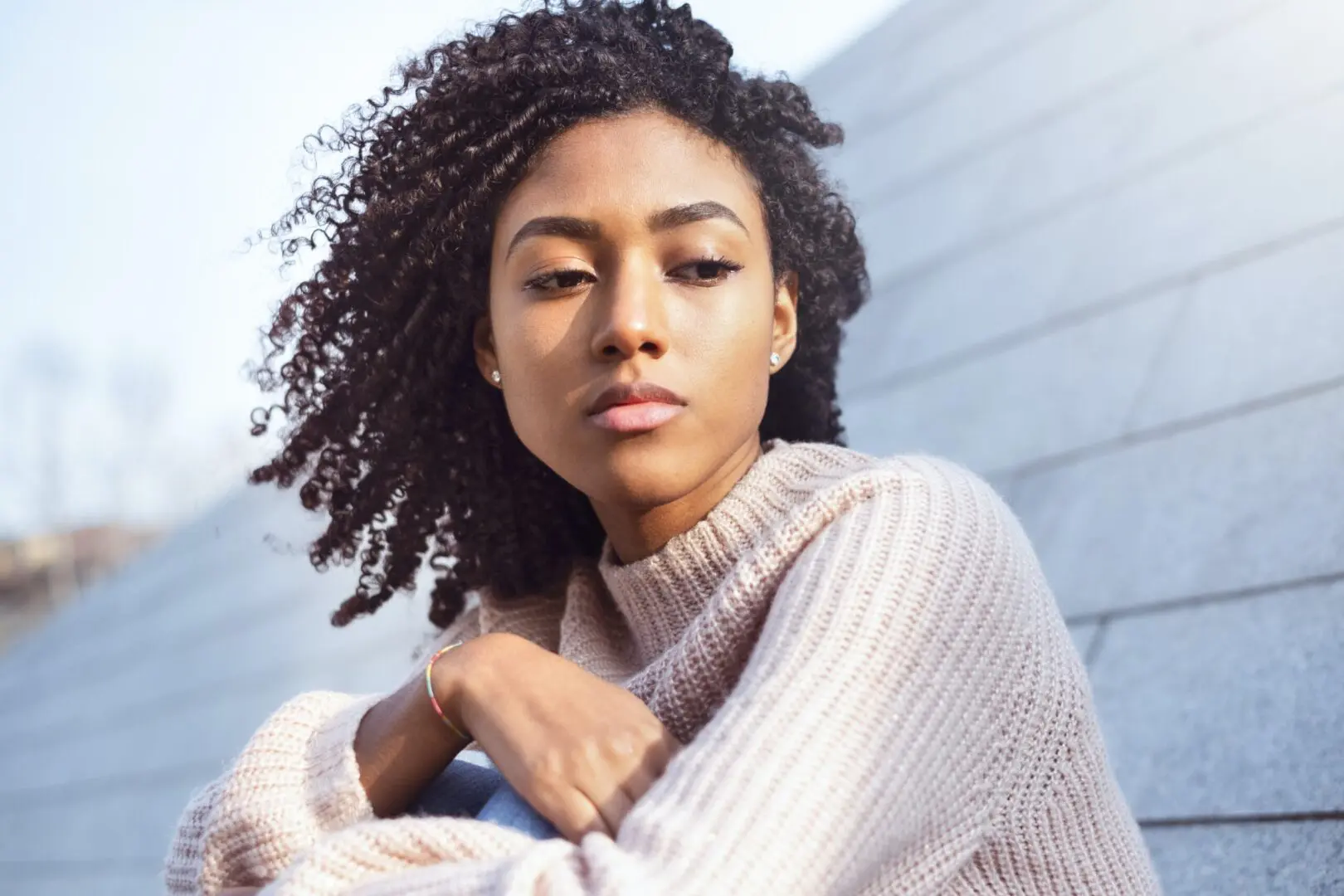 brown sweater | grief counseling in Atlanta, GA | Atlanta grief counselor | grief and loss counseling in Atlanta | 30135 | 30004 | 30034 Image of an African American woman looking off to the side. Representing the pain that grief and loss counseling can help with. During grief counseling in Atlanta, GA a grief counselor will help you make sense of life after loss.