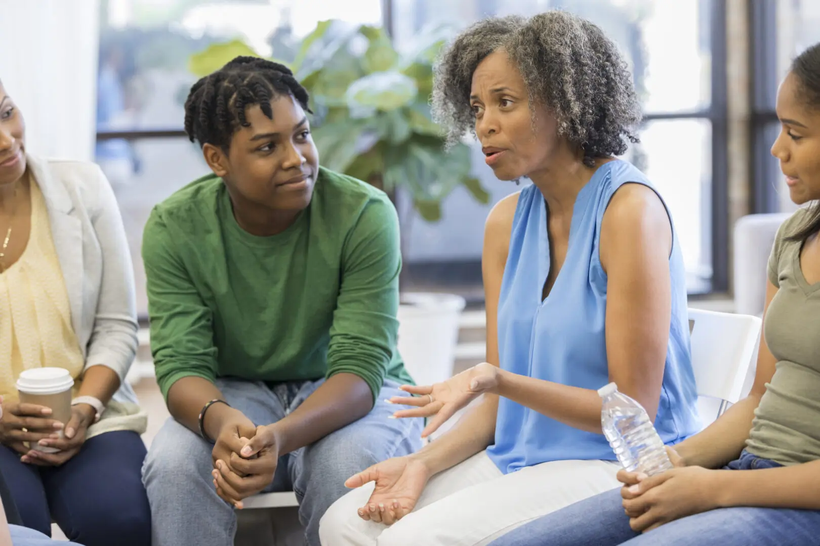 blue shirt | group therapy in Atlanta, GA | Atlanta group therapist | anxiety group therapy in Atlanta | 30080 | 30339 | 30067 Image of a Black group therapist in a blue shirt meeting with other women. Showing what group therapy can look like in Atlanta, GA. You can even get specific anxiety group therapy in Atlanta.