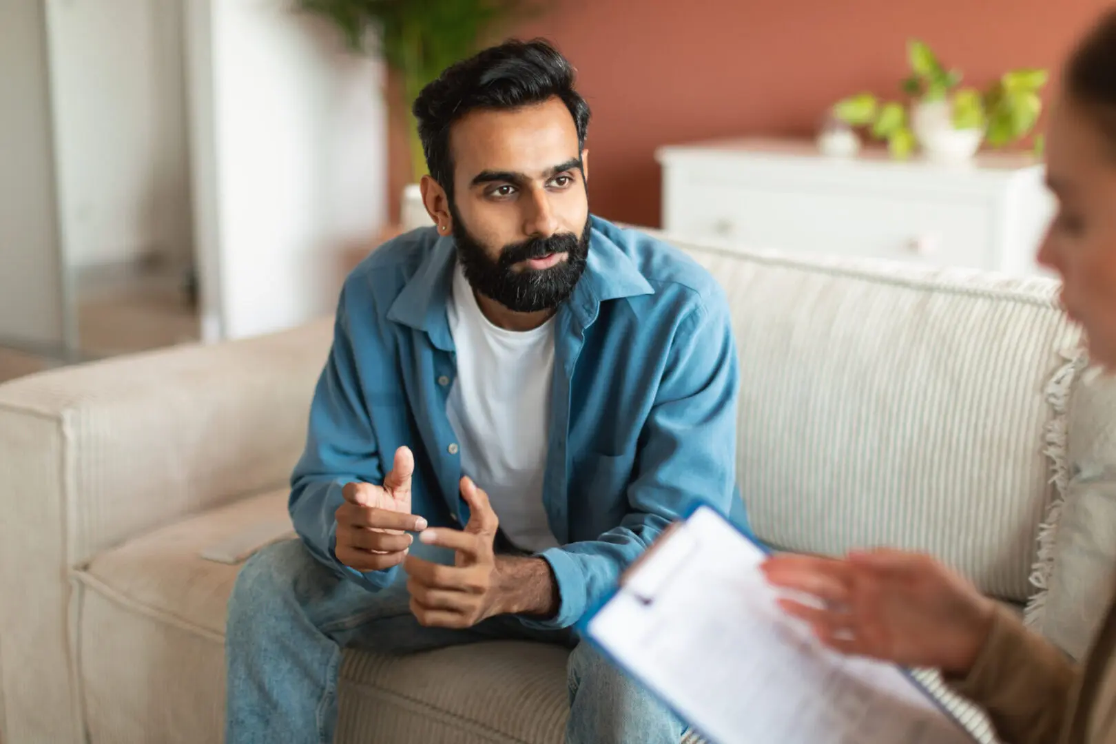 Indian Man Exploring Mental Health Through Therapy | Pakistani Therapist Atlanta Georgia | 30092 | 30331 | 30030 Young Indian man consulting with professional psychologist sitting indoor