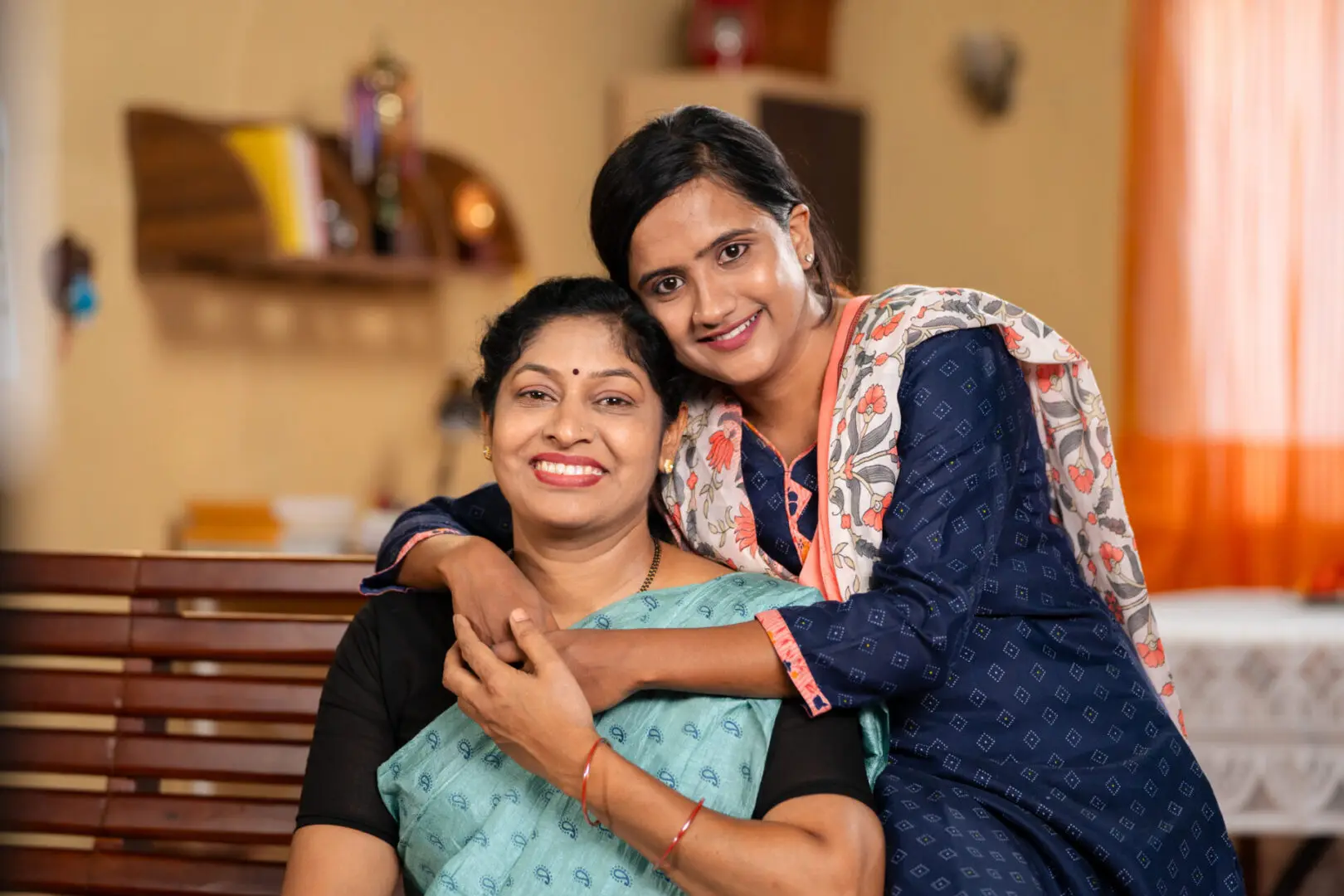 happy smiling Mother with daughter looking at camera by embracing or hugging each other at home - concept of family support, companion and emotional bonding. Image of a woman of color sitting on the floor by a couch. There are a lot of options when it comes to anxiety help. With anxiety therapy in Atlanta, GA you can start getting to the source of your worry. An anxiety therapist can help you understand where your anxiety symptoms are coming from. Call today!