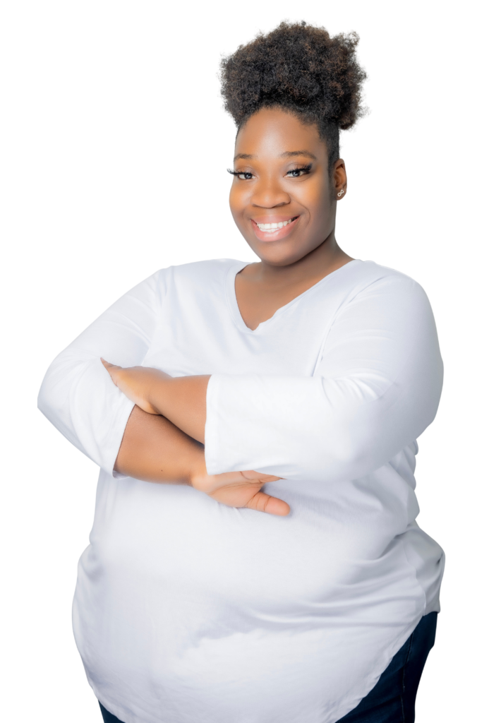 Smiling Black woman therapist with natural hair, wearing a white top, in her Atlanta, Georgia office, specializing in trauma therapy and emotional support.