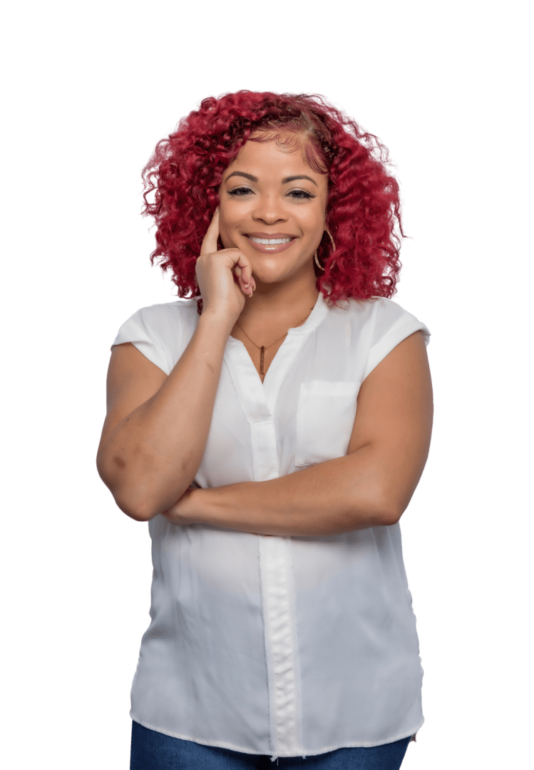 Smiling Black woman therapist with natural hair, wearing a white top, in her Atlanta, Georgia office, specializing in trauma therapy and emotional support.