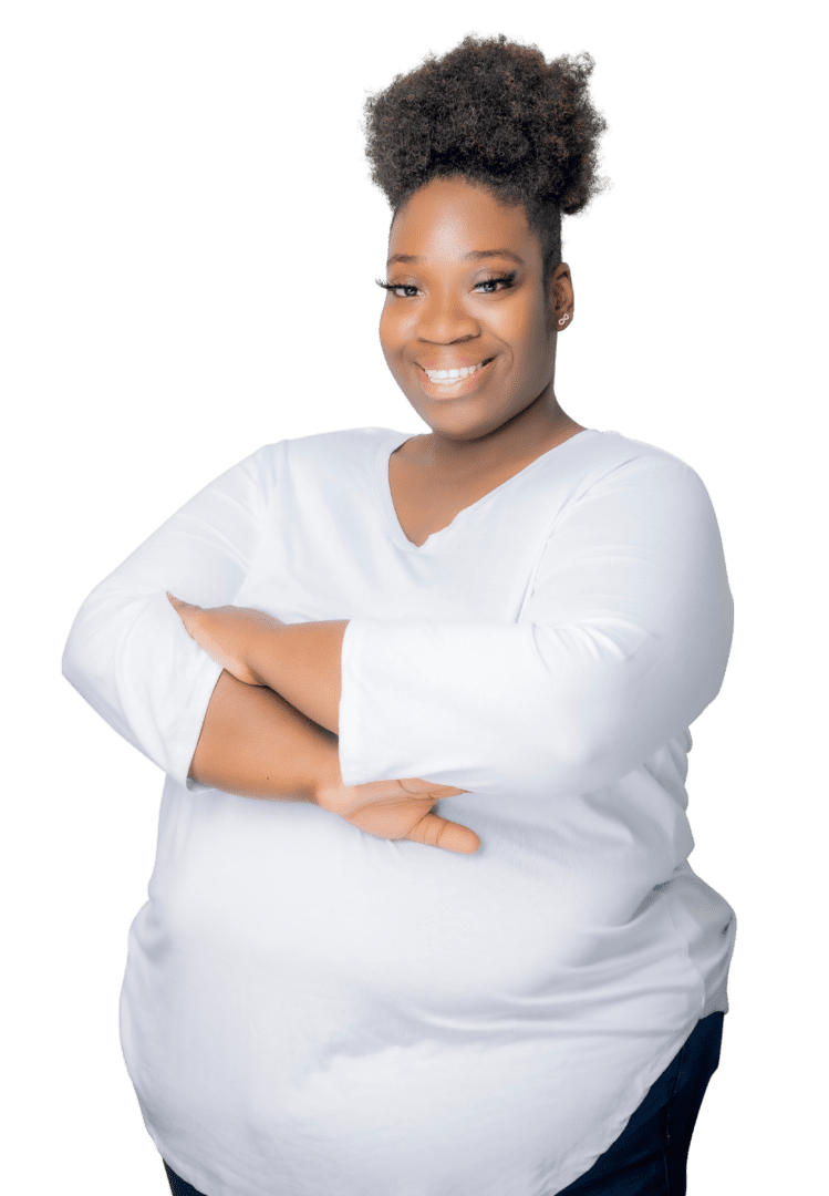 Smiling Black woman therapist with natural hair, wearing a white top, in her Atlanta, Georgia office, specializing in trauma therapy and emotional support.