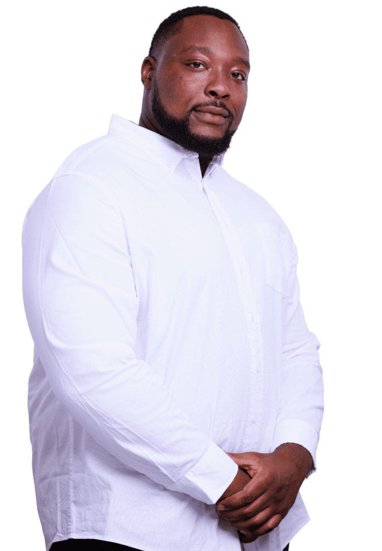 Black male mental health professional in Atlanta, Georgia, with a beard, wearing white shirt smiling warmly, specializing in depression and anxiety treatment.