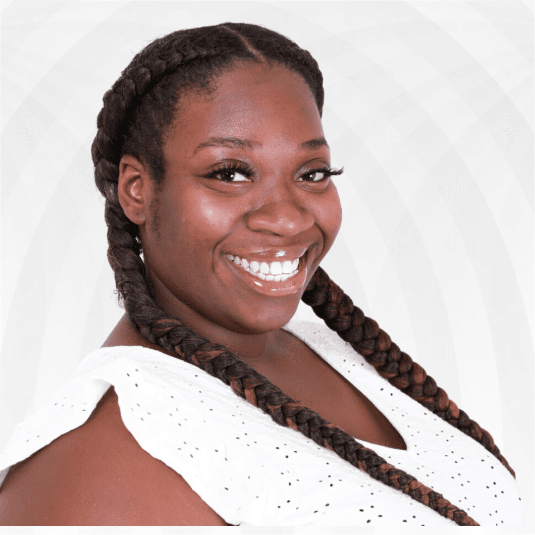 Smiling Black woman therapist in Atlanta, wearing a white top, providing anxiety therapy and trauma therapy for Black women.