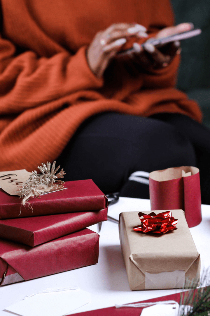 Image of a woman in a black sweater surrounded by holiday supplies. Representing the importance of mental health in the black community in Atlanta during the holidays. It can be easier with support of an Atlanta therapist in therapy for black people in Atlanta, GA.