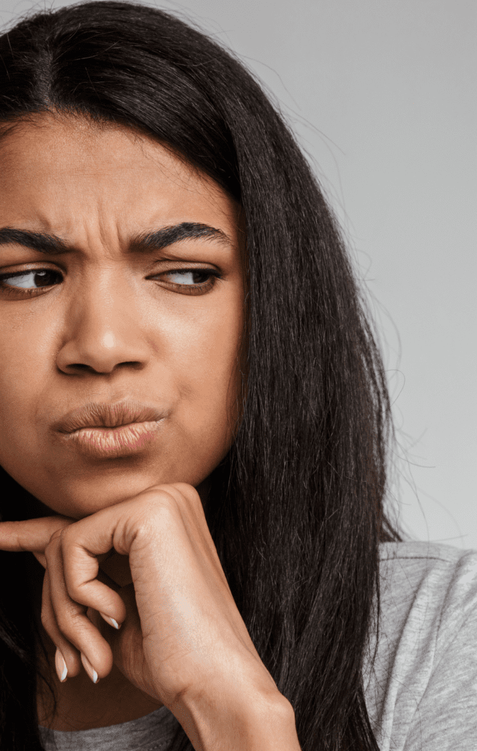 Woman looking confused following sting of microaggression. Therapist helping Black women address microaggressions and mental health challenges in Atlanta