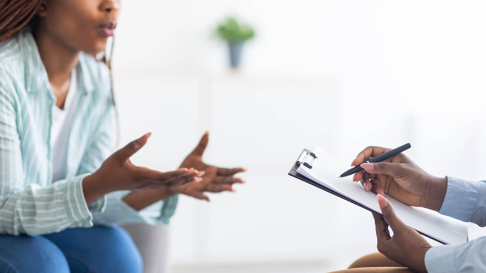 Black women in striped blue shirt talking to therapist during Court ordered assessment services for individuals in Atlanta for legal purposes