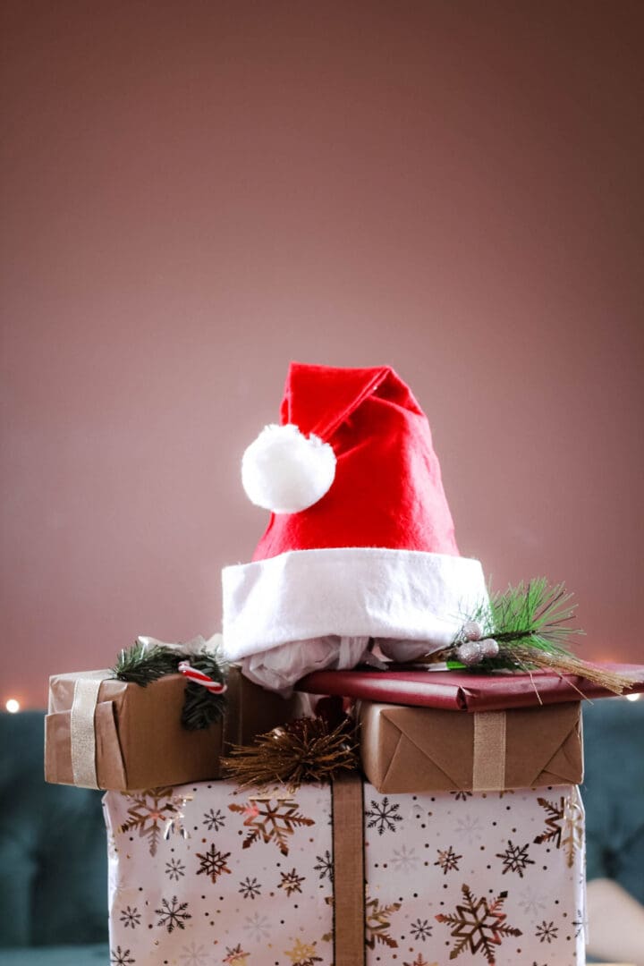 Christmas hats and presents, symbolizing holiday joy and the importance of incorporating self-care for peace and stress relief