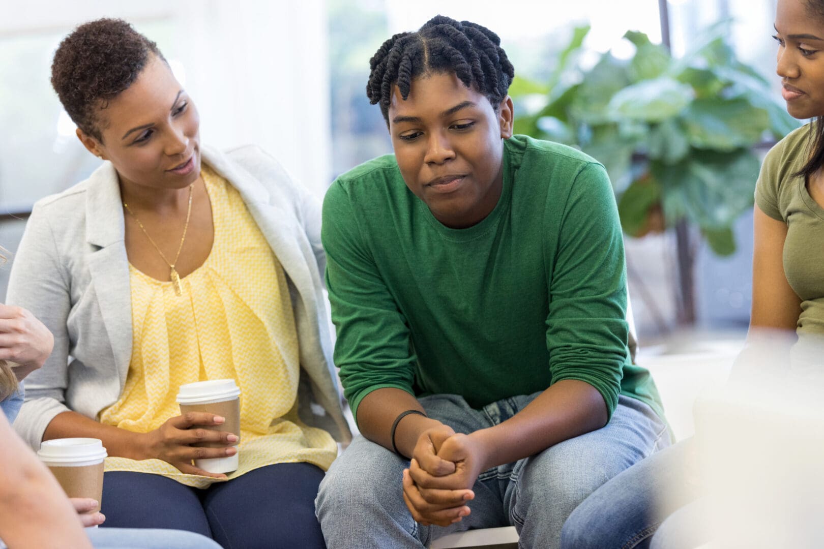 Image of a woman in a green shirt taking part in group therapy in Atlanta, GA. Showing what to expect from anxiety group therapy in Atlanta. Where a 