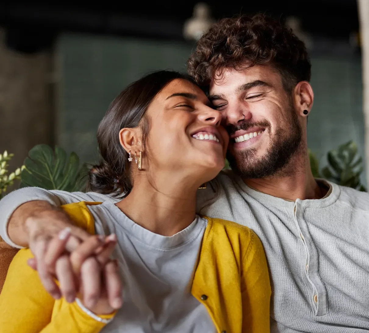 Happy BIPOC couple embracing with great affection.