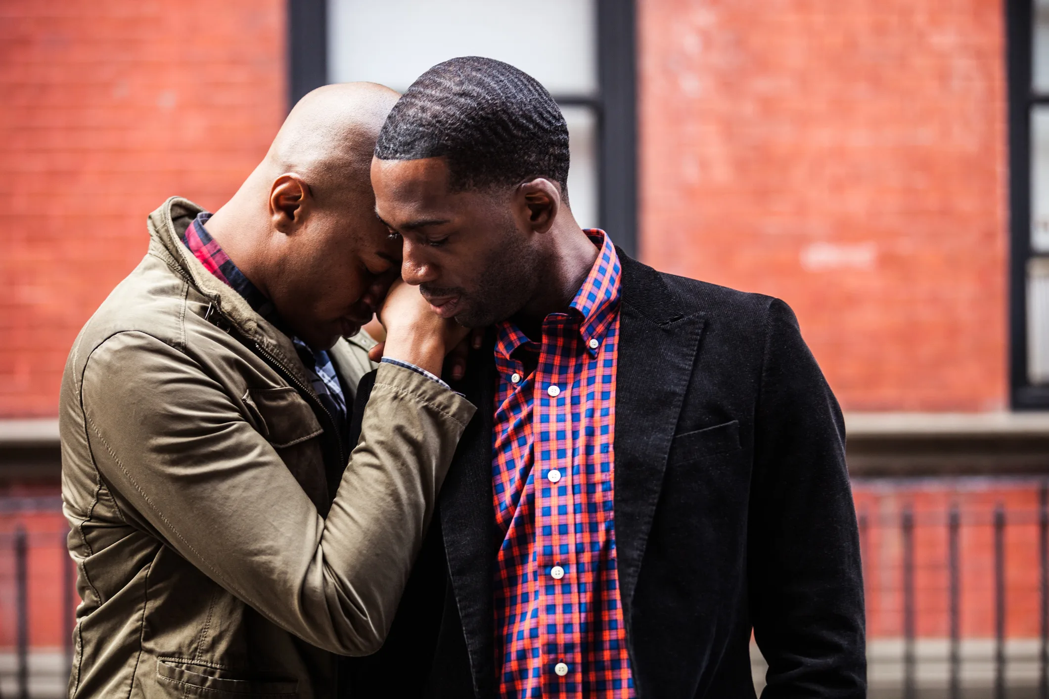 Image of a young African American male Homosexual couple embracing after meeting with an Atlanta relationship counselor. Address communication and relationship problems during relationship counseling in Atlanta, GA.