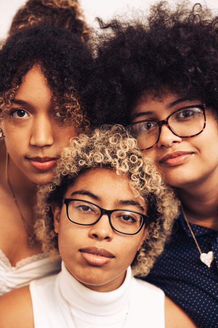 Black woman smiling in a group therapy session, benefiting from the emotional support and confidence-building offered by group therapy."