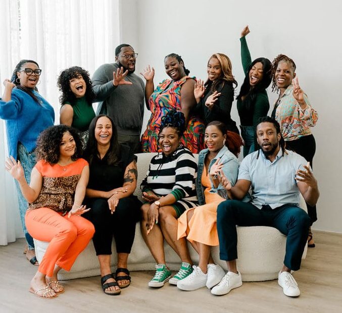 Eight Black Therapists wearing blue and white posing for photo in natural light. Representing Simplicity Psychotherapy group practice for Black men and women