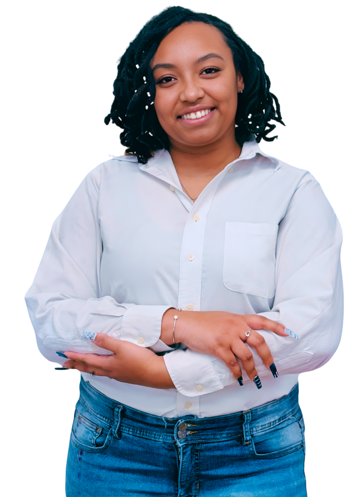 Smiling Black female therapist wearing a light blue button-down shirt and jeans, standing with arms crossed, representing anxiety therapy, identity exploration, and trauma therapy in Georgia (30080, 30339, 30067, 30213).